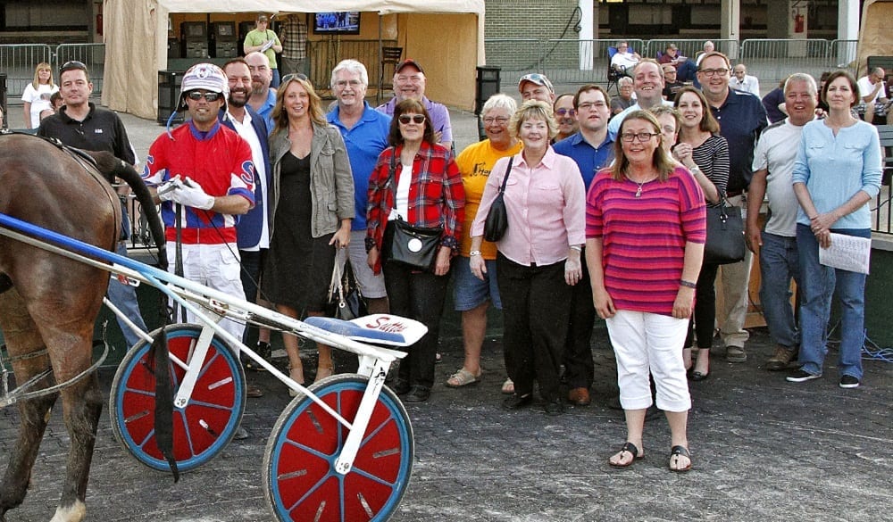 Members of the HorsePlay Racing Stable celebrate Odds On Serpens’ victory on May 18 at Scioto Downs | Brad Conrad