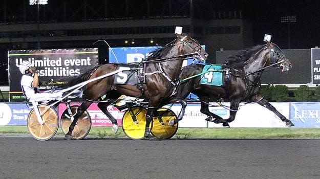 Huntsville (Tim Tetrick) held off rival Downbytheseaside (Brian Sears) at the wire to win the $738,550 Crawford Farms Meadowlands Pace in 1:47.4 | Michael Lisa