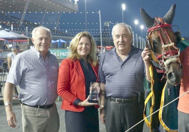 Buckley (with trainer John Bax (left) and owner/breeder Jim Bullock in the Mohawk winner's circle) is hoping to make a strong connection with the standardbred horsepeople | New Image Media