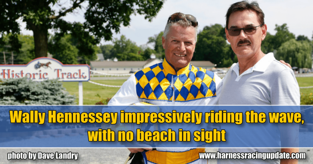 Wally Hennessey impressively riding the wave, with no beach in sight